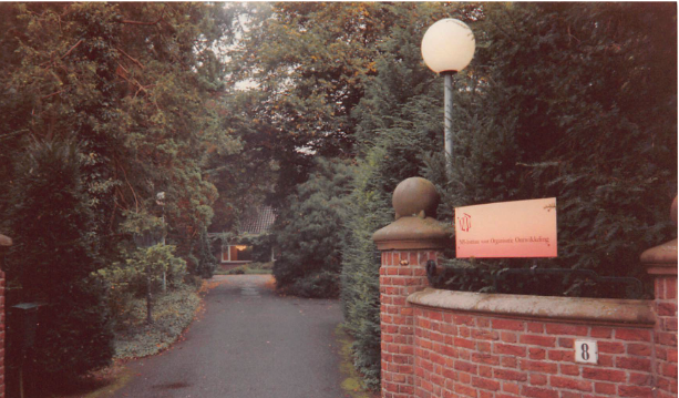 Archival photo of the entrance driveway and gate of the former NPI building in the Netherlands